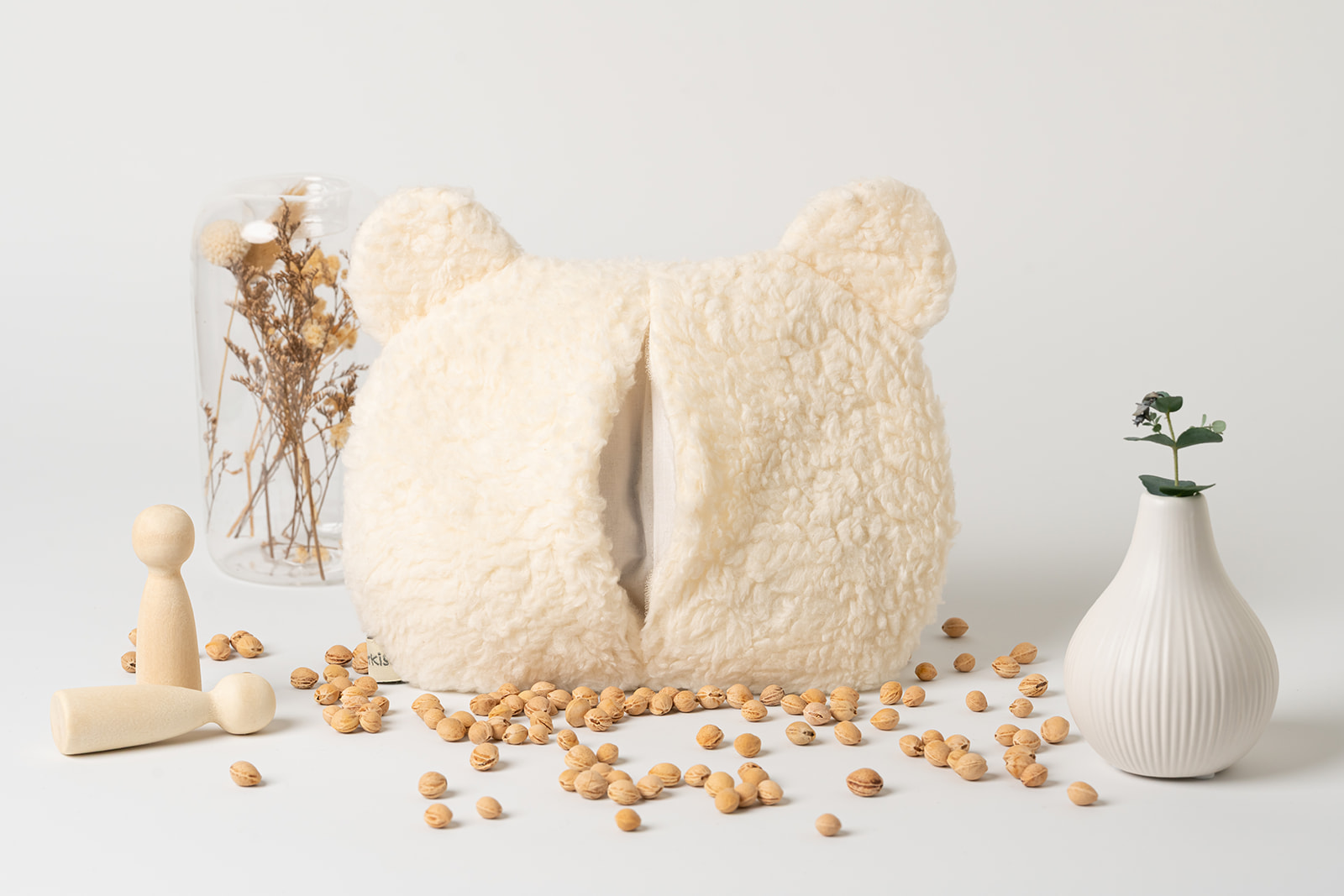 Wärmekissen Bär | personalisiert | verschiedene Farben 7 Kirschkernkissen Bär in Farbe creme. Zu sehen ist die Rückseite mit geöffnetem Überzug aus Biobaumwollplüsch. Weiters zu sehen ist ein Blick ins Kissen, wo das Innenkissen zu finden ist. Dieses ist ebenfalls mit einem Klettverschluss versehen, damit die Kerne immer wieder ausgetauscht werden können.